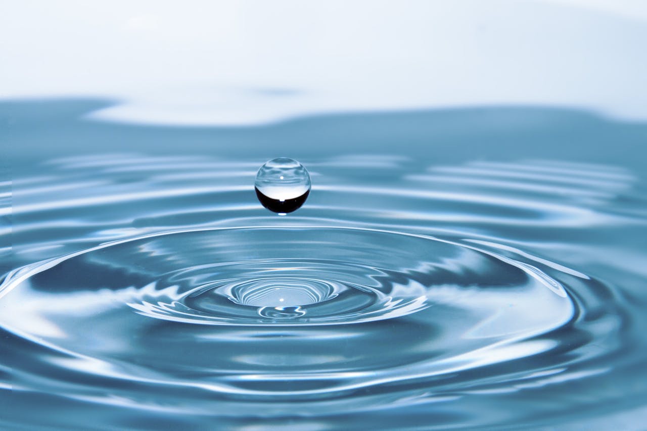 services-03 A mesmerizing shot of a water droplet capturing the beauty of liquid dynamics.